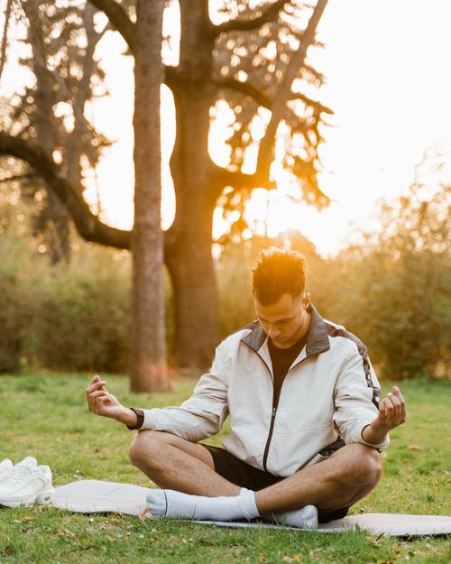 A person in a seated meditation pose feeling calm and focused.